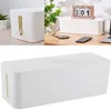 Collage showing a white cable organizer box in different settings, including on a desk with a plant and calendar, and a close-up view. Anteprima dell’immagine prodotto