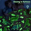 Two children sleeping under a glowing dinosaur blanket. Náhled obrázku produktu