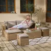 A woman relaxing on a patio furniture set, reading a book. Produktbild-Vorschau