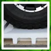A close-up view of a vehicle tire resting on a white pallet, with a green border around the image. Produktbild-Vorschau