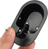A hand is holding a black metal recliner chair release handle. Produktbild-Vorschau