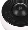Close-up view of the top surface of a white and black electronic device, showing control buttons and a central lens. Anteprima dell’immagine prodotto
