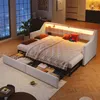 A modern bedroom or living room setting with a sofa bed extended and drawers open, showcasing storage. Voir les images du produit