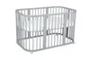 A gray crib with a white mattress on a white background. Produktbild-Vorschau