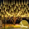 Outdoor scene at night with a decorated tree and Christmas tree. Produktbild-Vorschau