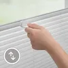 A hand is shown adjusting a white pleated blind. Produktbild-Vorschau