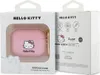 The image shows the retail packaging for a Hello Kitty AirPods Pro case. The front of the box displays the pink case through a clear window, and the side of the box has product information and branding. Produktbild-Vorschau