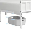 Close-up view of the underside of a white metal bed frame, showing a gray storage bin hanging from it, with measurement indicators. Produktbild-Vorschau