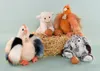 A group of plush farm animals and a rabbit sitting on a bale of hay with eggs. Produktbild-Vorschau