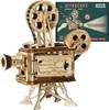 A wooden model of a vintage film projector is shown against a white background, with a box of the product in the upper right corner. Náhľad obrázku produktu