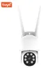 A white smart WiFi camera with two antennas is shown against a white background. The Tuya logo is visible in the top left corner. Voir les images du produit