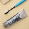 A toothbrush with toothpaste and a tube of toothpaste are laid out on a light-colored surface. Produktbild-Vorschau
