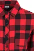 A close-up view of a red and black checkered flannel shirt. Náhled obrázku produktu