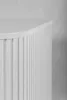 A close-up view of a white cabinet with vertical ribbed detailing. Náhled obrázku produktu