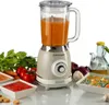 A retro-style blender filled with orange liquid, surrounded by fresh vegetables and bowls of soup and sauce. Produktbild-Vorschau