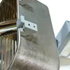 A close-up view of a gray plastic bracket attached to a stainless steel sink. Produktbild-Vorschau