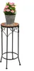 A potted plant with pink flowers sits on a decorative plant stand. Produktbild-Vorschau
