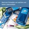 A collection of kitchen tools and fresh vegetables arranged on a white surface. Produktbild-Vorschau