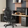 A gaming chair is set up in a home office environment with a desk, monitors, and computer. Náhľad obrázku produktu