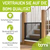 A baby gate installed on a wooden staircase. Produktbild-Vorschau