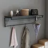 A wall-mounted coat rack with a shelf and hooks, displaying various items. Anteprima dell’immagine prodotto