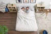 A couple sleeping peacefully on a large air mattress in a bedroom setting. Produktbild-Vorschau