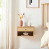 A floating nightstand with a drawer and open shelf, decorated with a vase of dried flowers and a mug. Podgląd zdjęcia produktu