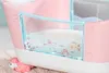 Close-up of a pink and white toy bathtub with a clear plastic front showing underwater illustrations. Produktbild-Vorschau
