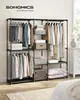 A neatly organized clothing rack with various garments and folded linens. Náhled obrázku produktu