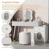 A white vanity table with a decorative mirror and a stool, set in a room with curtains. Podgląd zdjęcia produktu