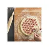 A person is making ravioli on a wooden board with a rolling pin nearby. Náhled obrázku produktu