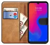 A book-style phone case with a phone, cards, and banknotes inside. Produktbild-Vorschau