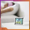 A person sleeping in bed with a weather station on a nightstand. Anteprima dell’immagine prodotto