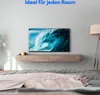 A modern bedroom with a wall-mounted TV displaying a wave image, a floating media console, and a bed with a blanket. Produktbild-Vorschau