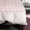 A close-up view of a duvet cover with a dotted circle pattern and a plain beige section. Produktbild-Vorschau
