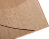 A close-up view of a beige and brown rug with a textured pattern and a dark brown border. Produktbild-Vorschau