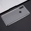 A clear phone case is placed on a dark surface next to a laptop. Produktbild-Vorschau