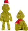 Two plush toys of the character The Grinch are displayed against a white background. One is standing and wearing a Santa hat, while the other is sitting and wearing a red scarf. Produktbild-Vorschau