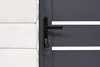 A close-up of a gray garden gate with a black handle and keys, next to a white brick wall. Produktbild-Vorschau