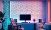 A modern gaming or home office setup with a computer, chair, and decorative wall panels. Produktbild-Vorschau