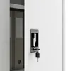 Close-up of a white metal cabinet door with a black lock and key. Voir les images du produit