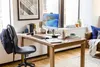 A home office setup with a desk, computer, and chair. Produktbild-Vorschau
