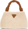 A studio shot of a beige fuzzy handbag with a braided brown handle and a Guess logo. Produktbild-Vorschau