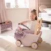 A young girl playing with a doll stroller in a nursery. Náhled obrázku produktu