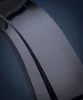 A close-up, abstract shot of a dark-colored watch band. Produktbild-Vorschau