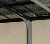 A close-up view of the structural components of a modern carport, showing metal beams, rivets, and transparent roofing panels. Podgląd zdjęcia produktu