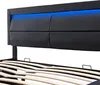 Close-up of a black upholstered bed frame with blue LED lighting. Podgląd zdjęcia produktu