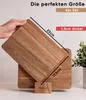 A hand holding a wooden cutting board with another cutting board underneath, showing dimensions and product details. Náhled obrázku produktu