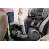 A person is using a handheld vacuum cleaner to clean a car seat. Produktbild-Vorschau