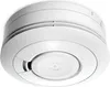 A white smoke detector is shown from a slightly elevated angle against a white background. Produktbild-Vorschau